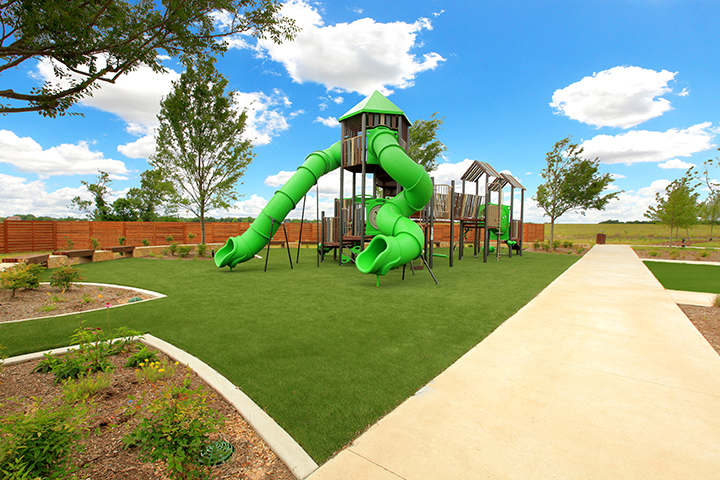 A green slide in a park.