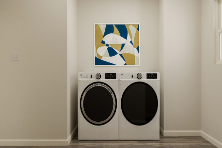 A white wall with a picture of a laundry basket and a painting on it.