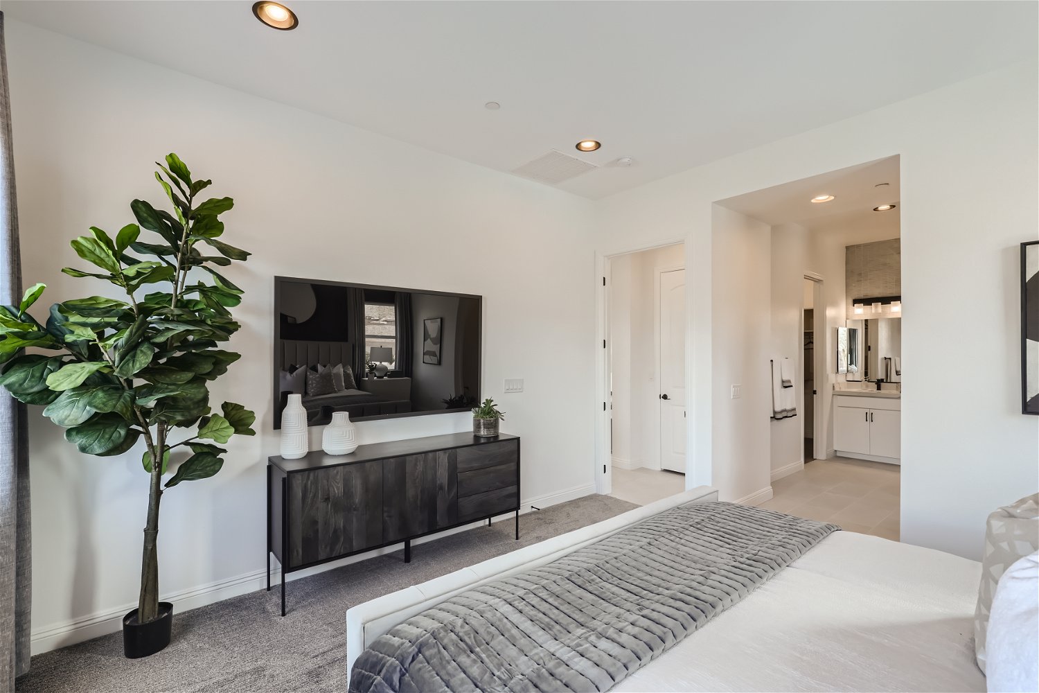 A bedroom with a bed and a tv.