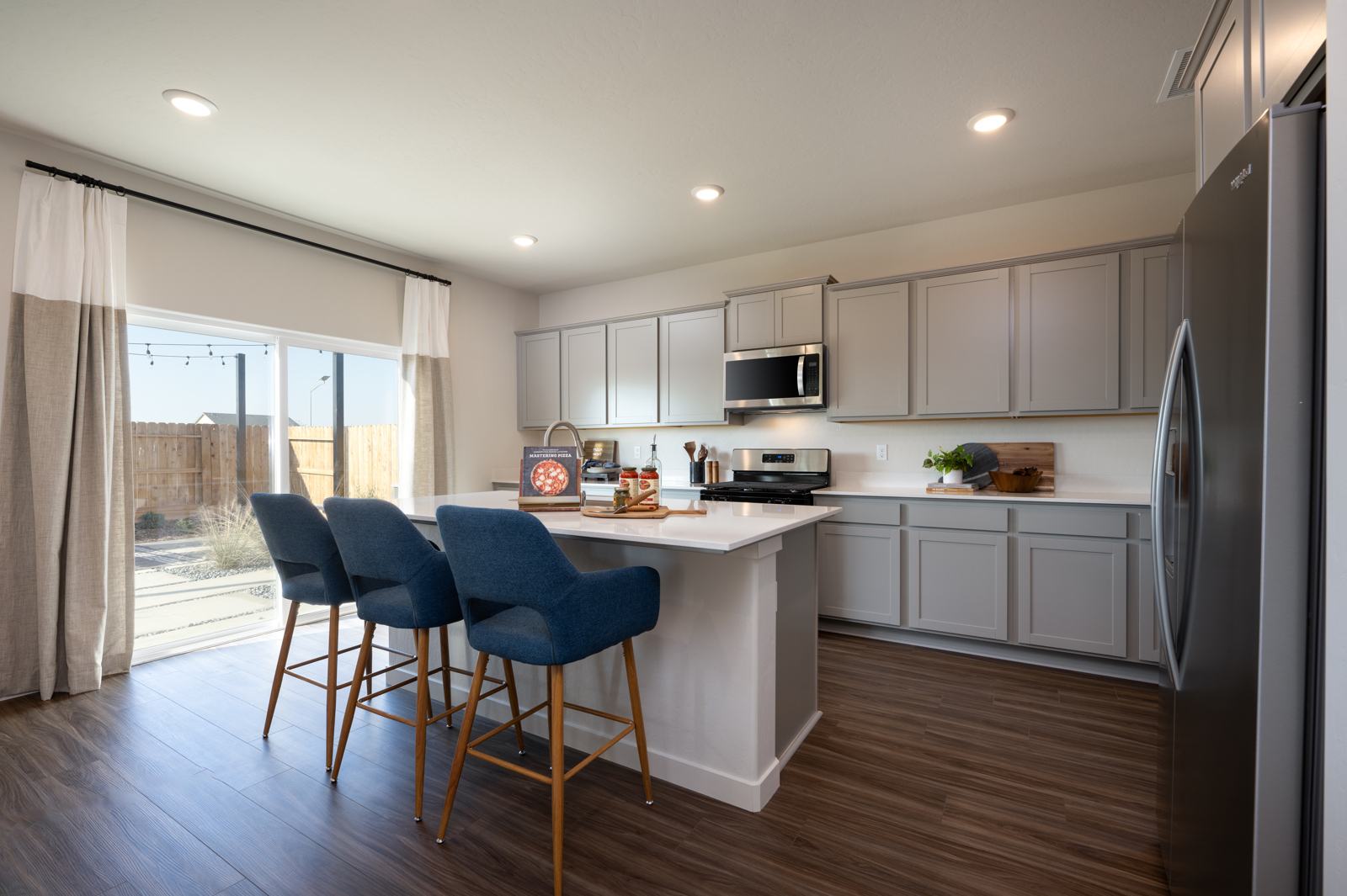 A kitchen with white cabinets.