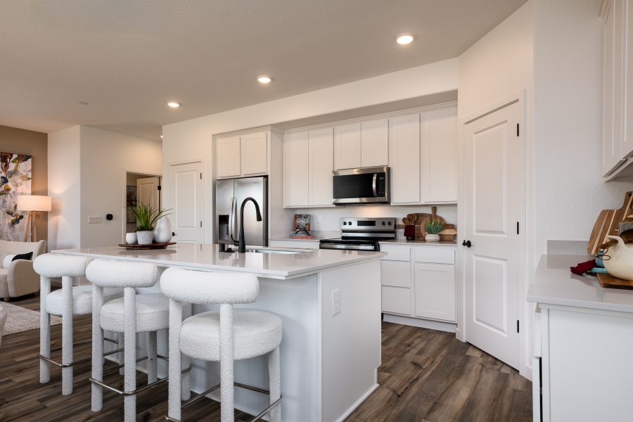 A kitchen with white cabinets.