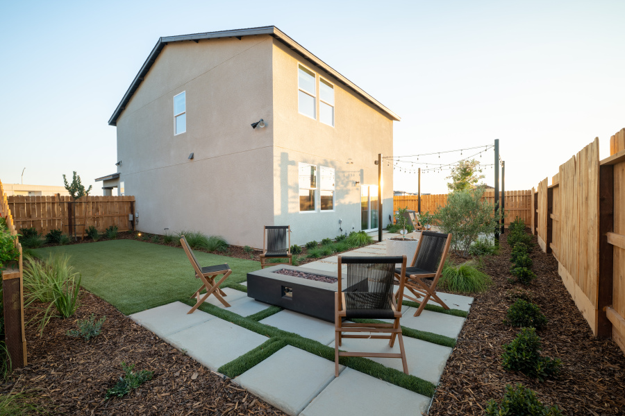 A backyard with a table and chairs.