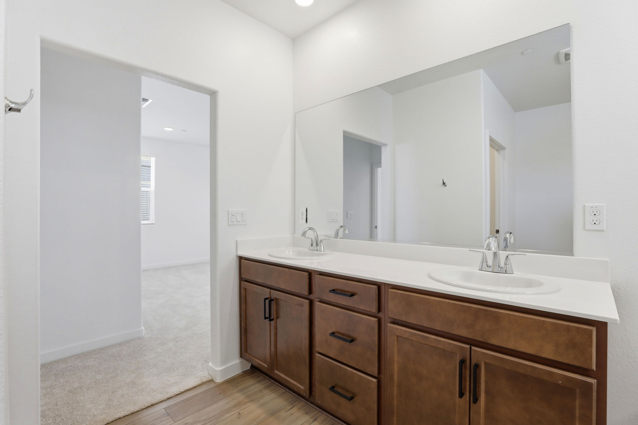 A bathroom with a large mirror.