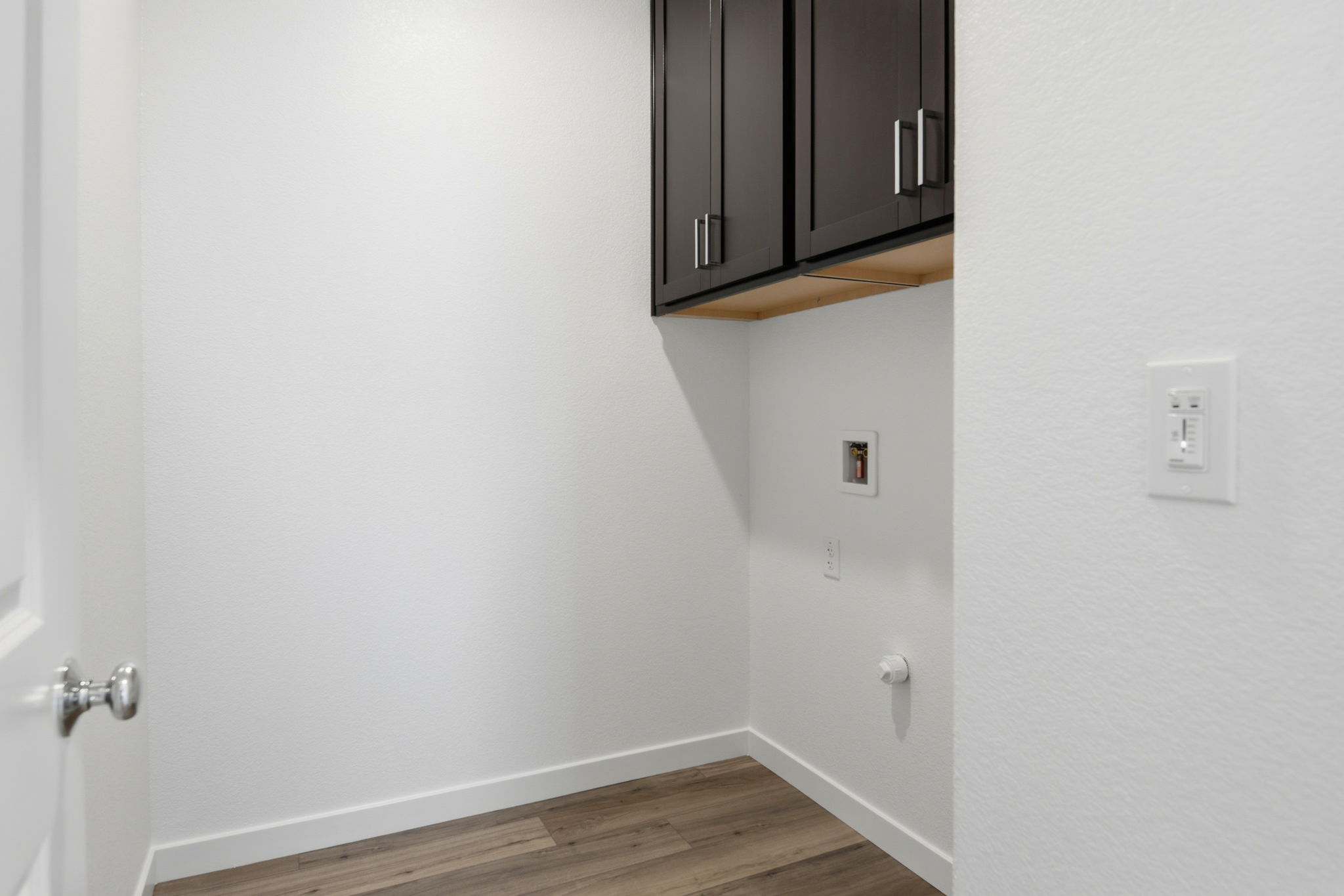 A room with a cabinet and a door.