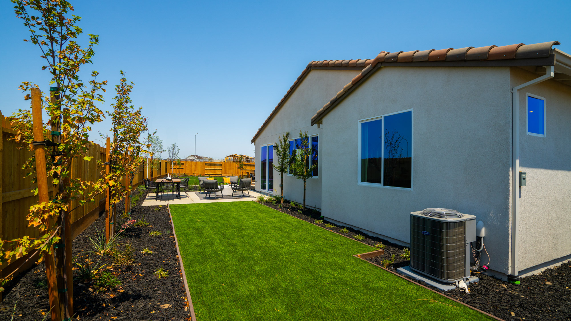 A house with a fence and yard.