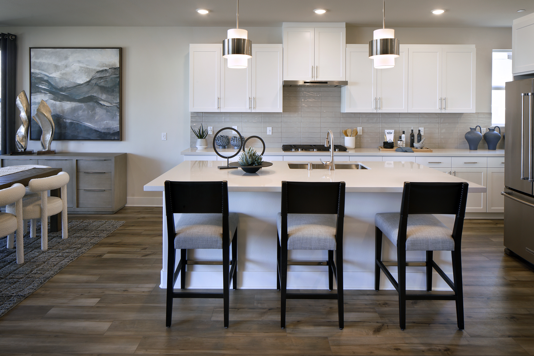 A kitchen with a dining table and chairs.