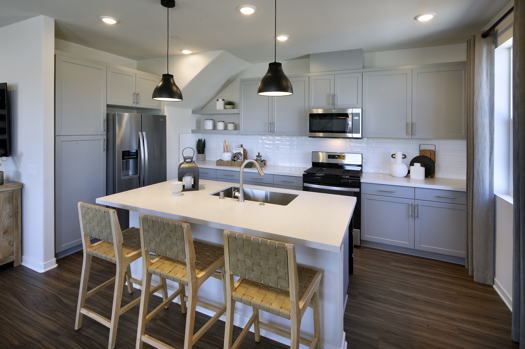 A kitchen with a table and chairs.