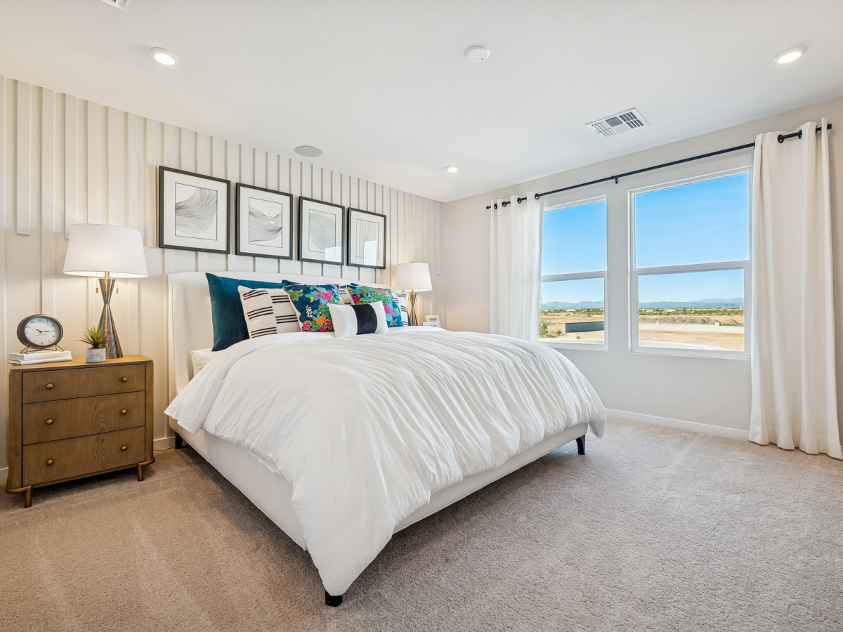 A bedroom with a bed and a window.