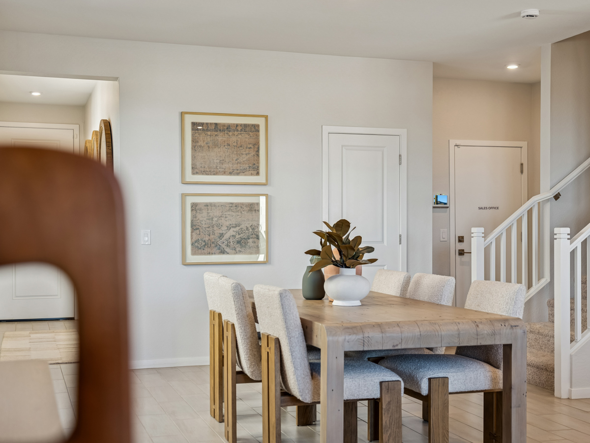 A dining room with a table and chairs.