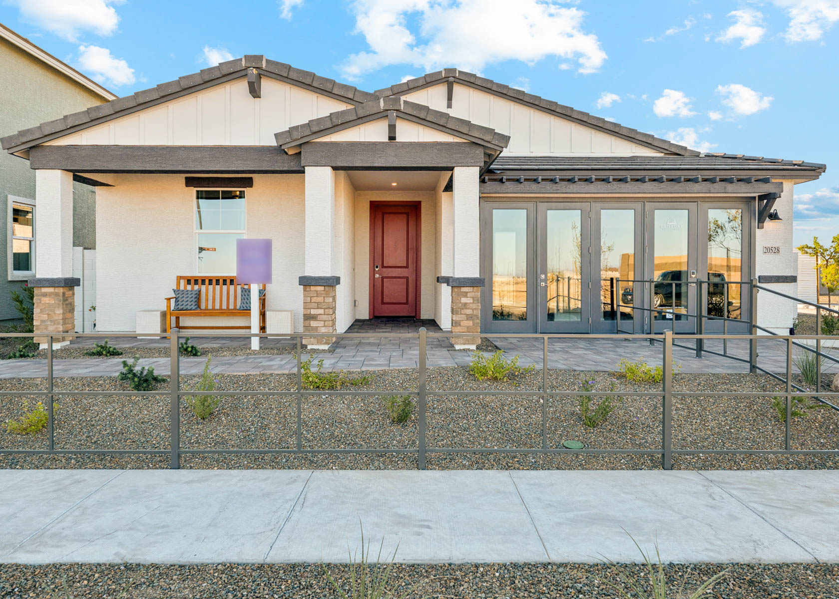 A house with a fence in front.