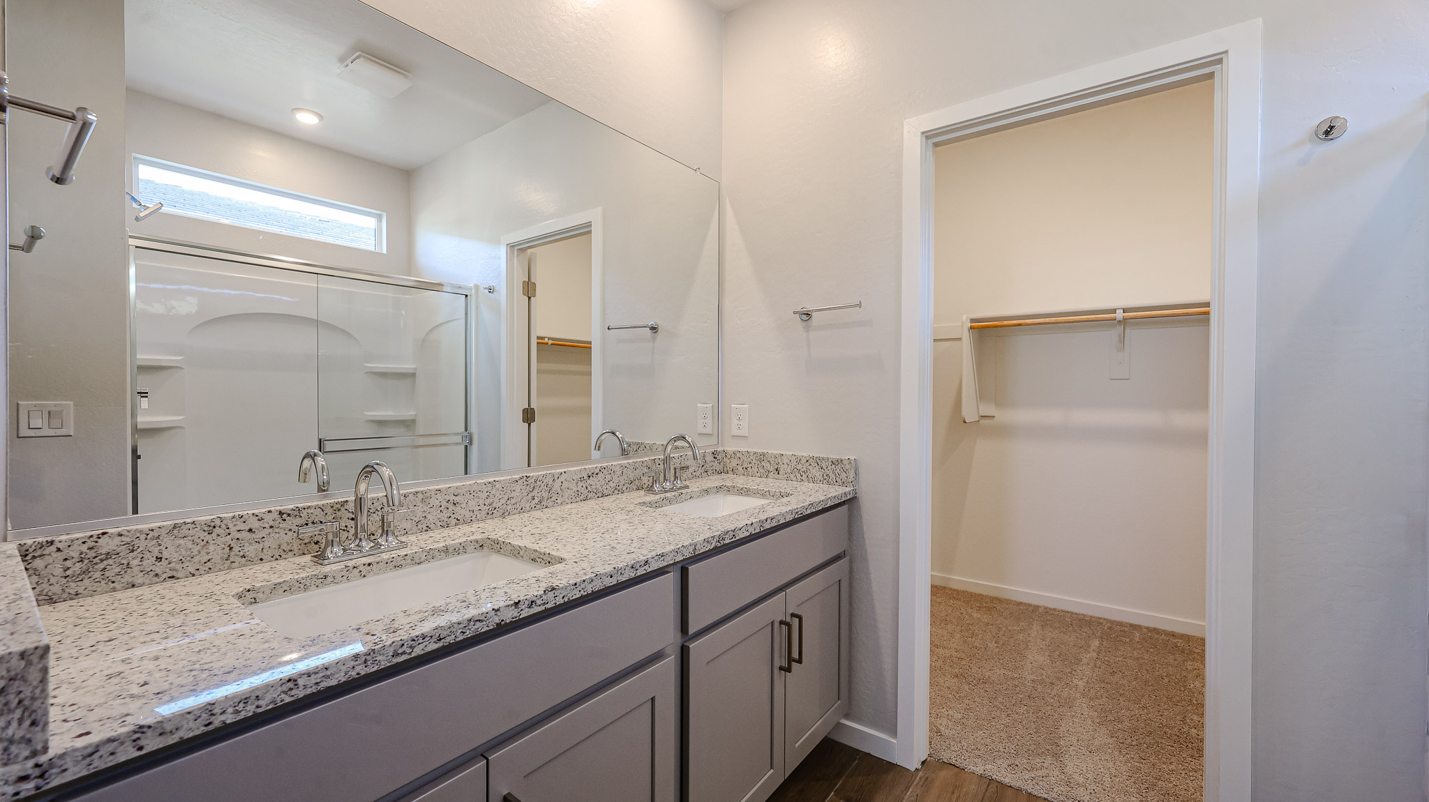 A bathroom with a large mirror.