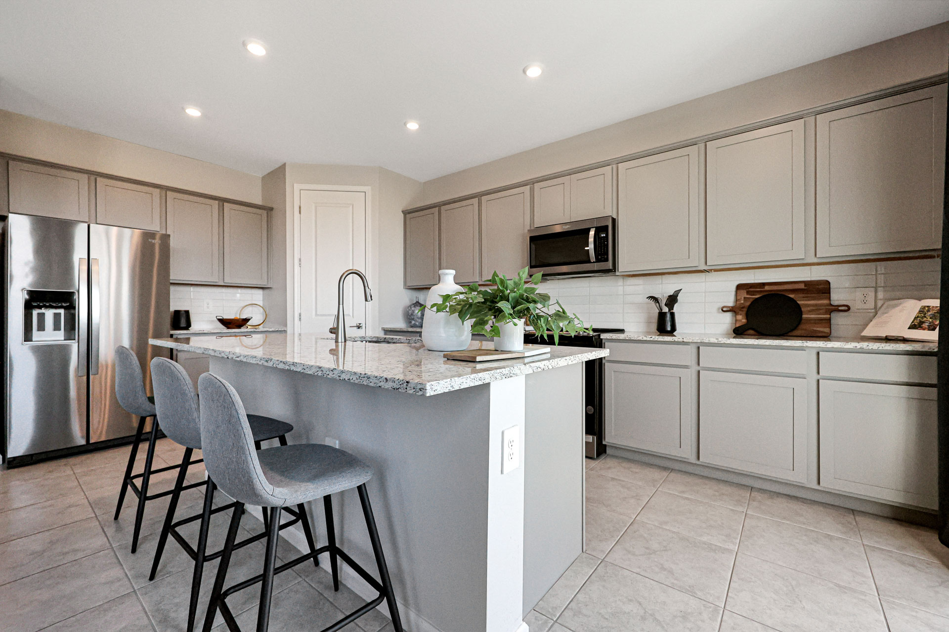 A kitchen with white cabinets.