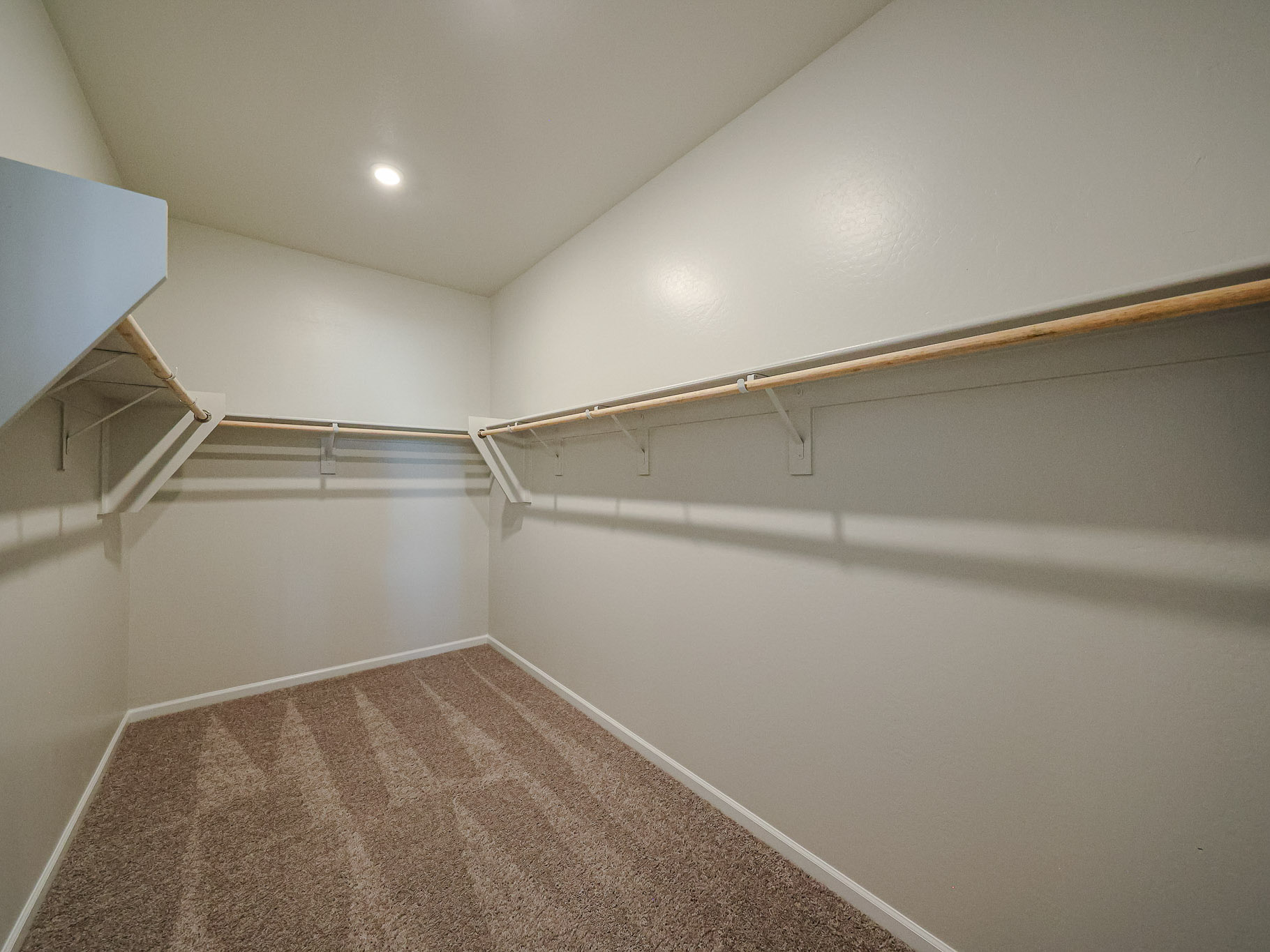 A room with a carpet and a rug.