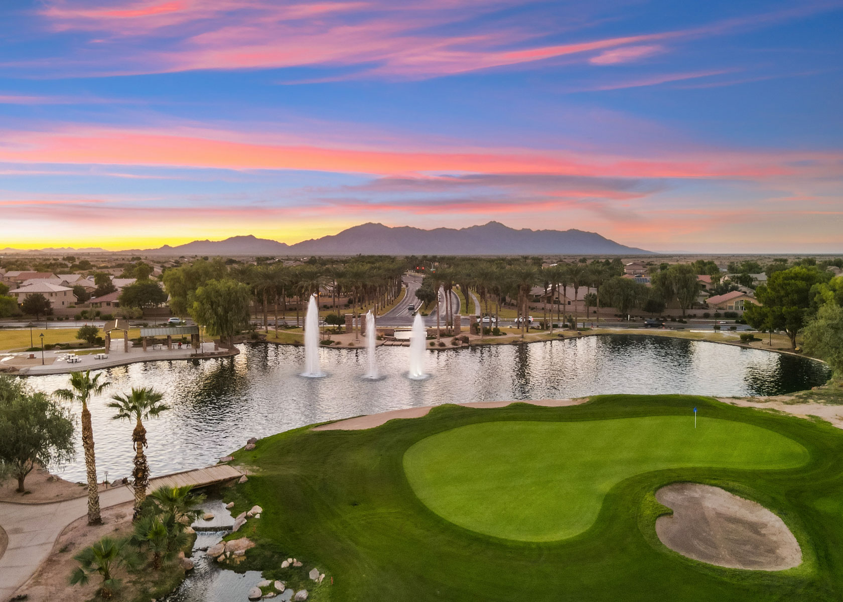 A golf course with a pond.