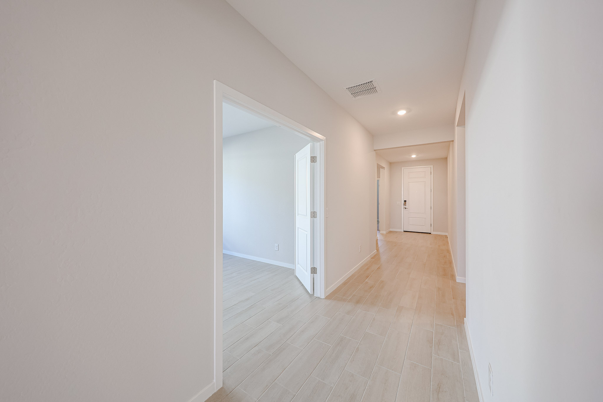 A hallway with white walls.