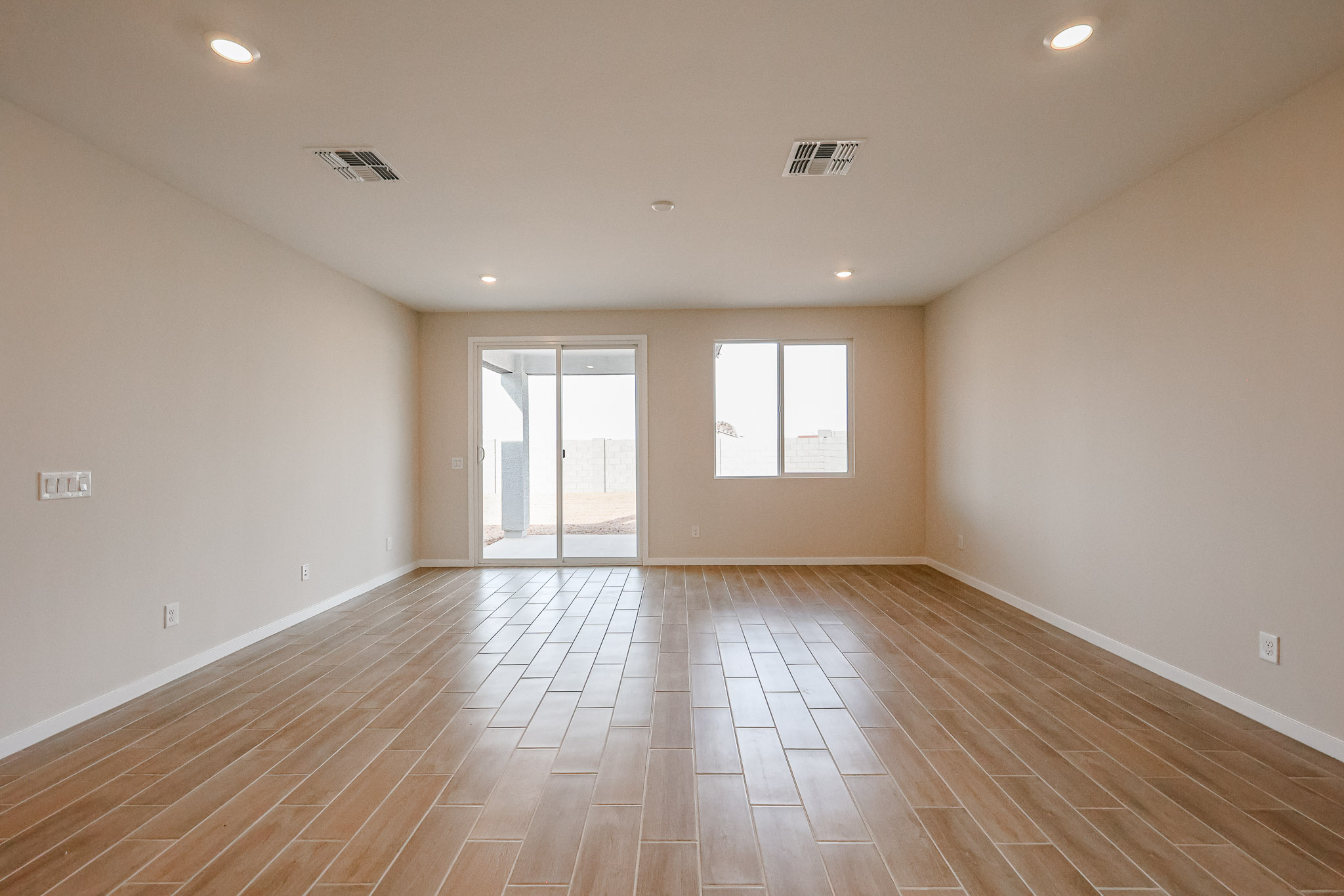 A room with a wood floor and windows.