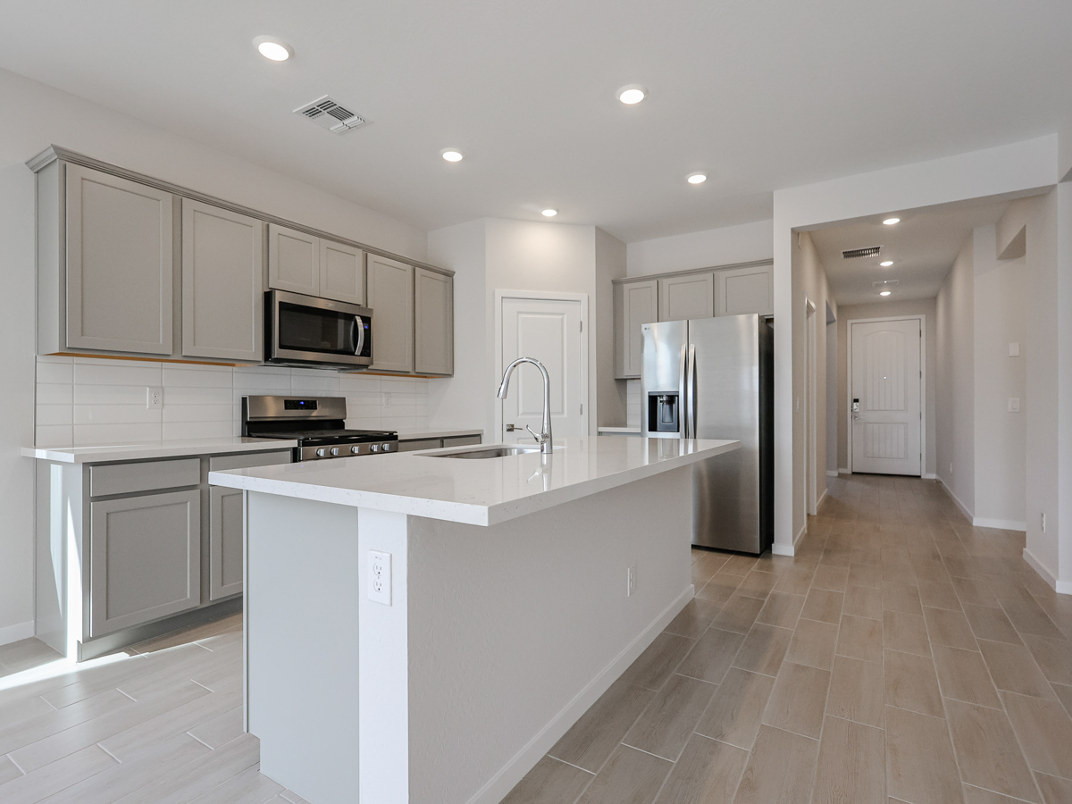 A kitchen with white cabinets.