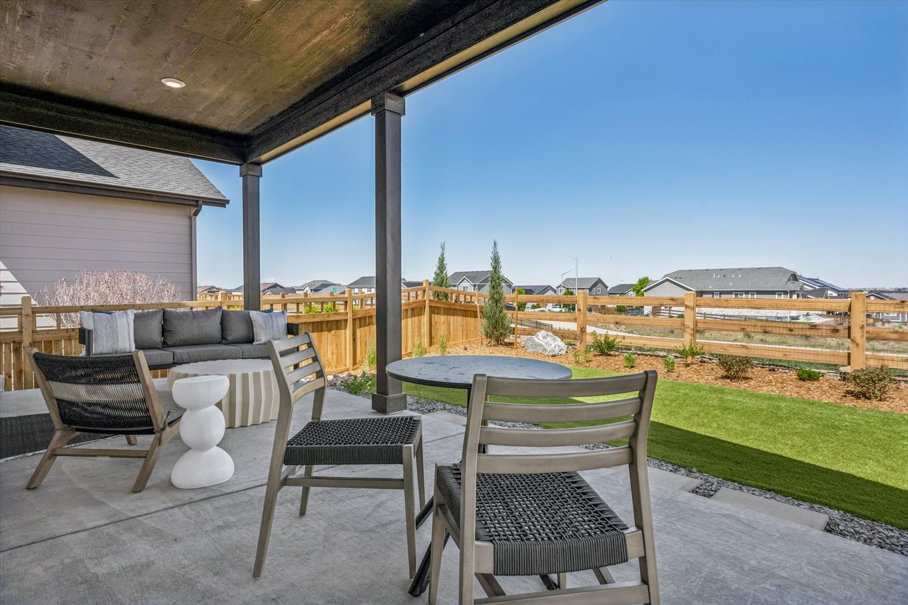 A patio with a table and chairs.