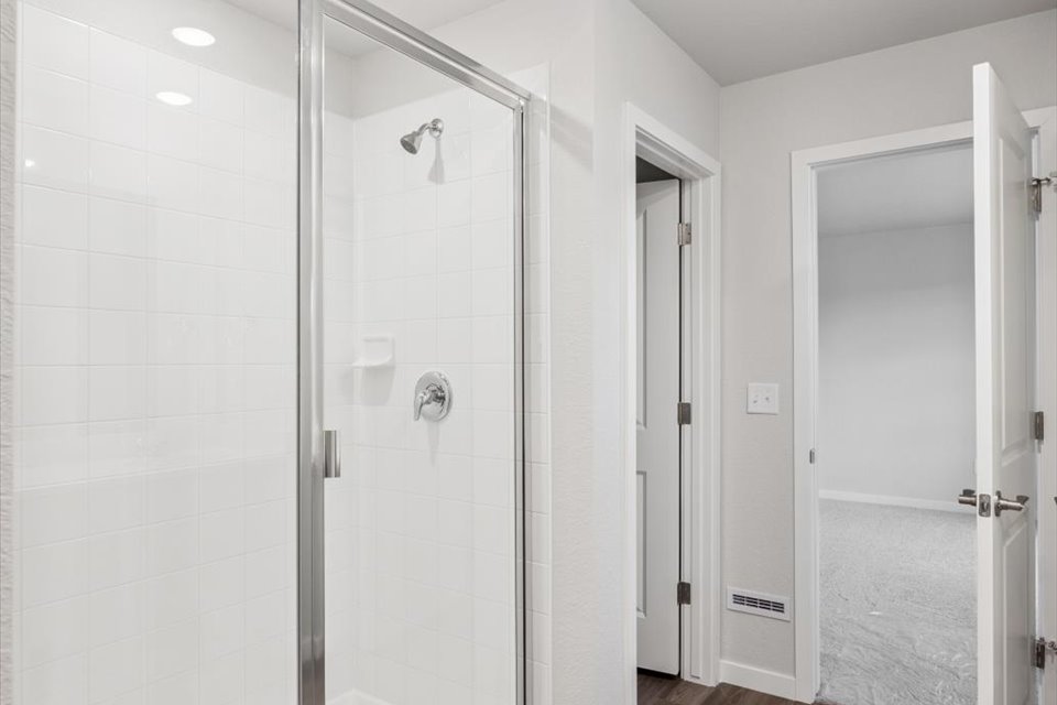 A shower with a glass door.