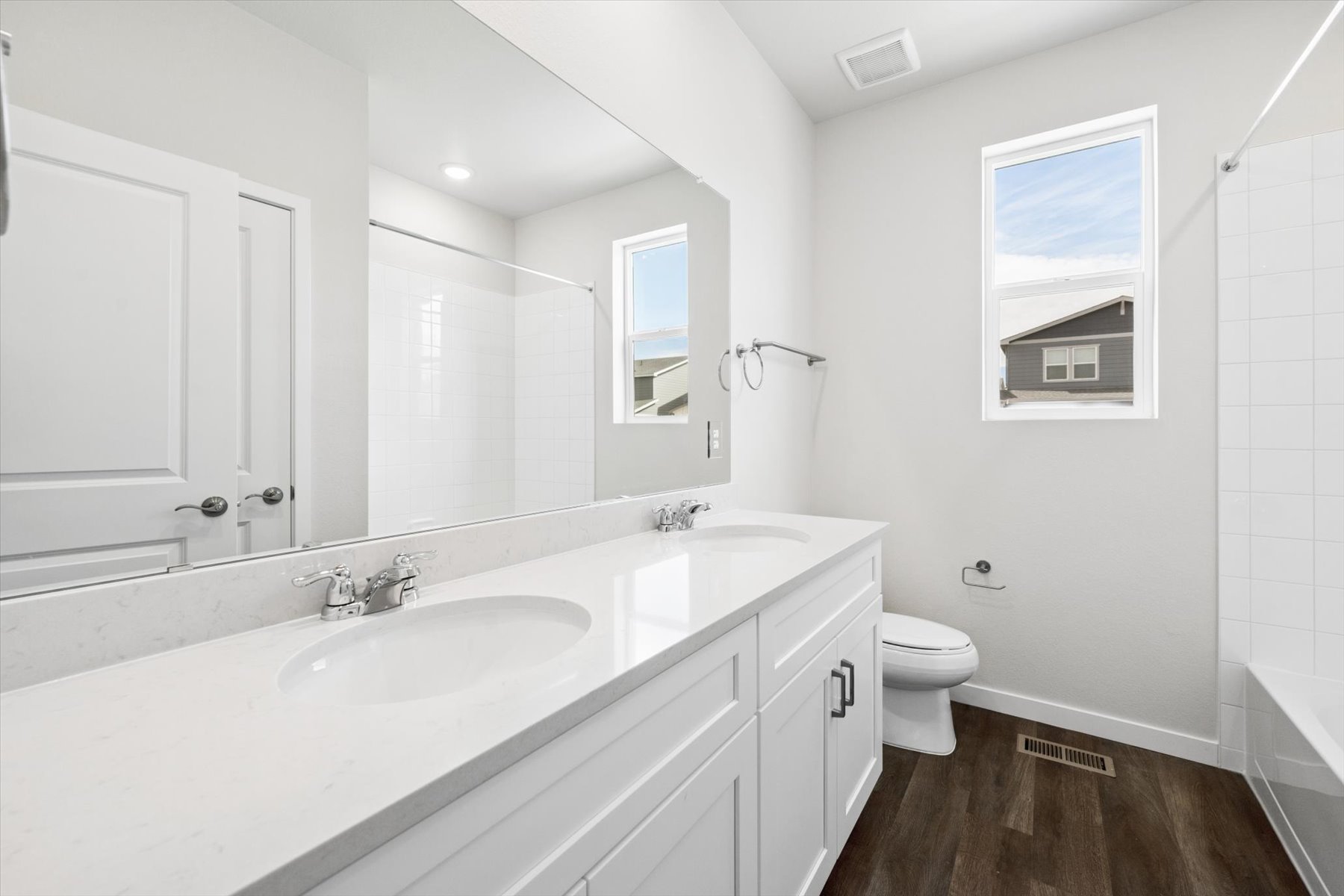 A bathroom with a tub sink and toilet.