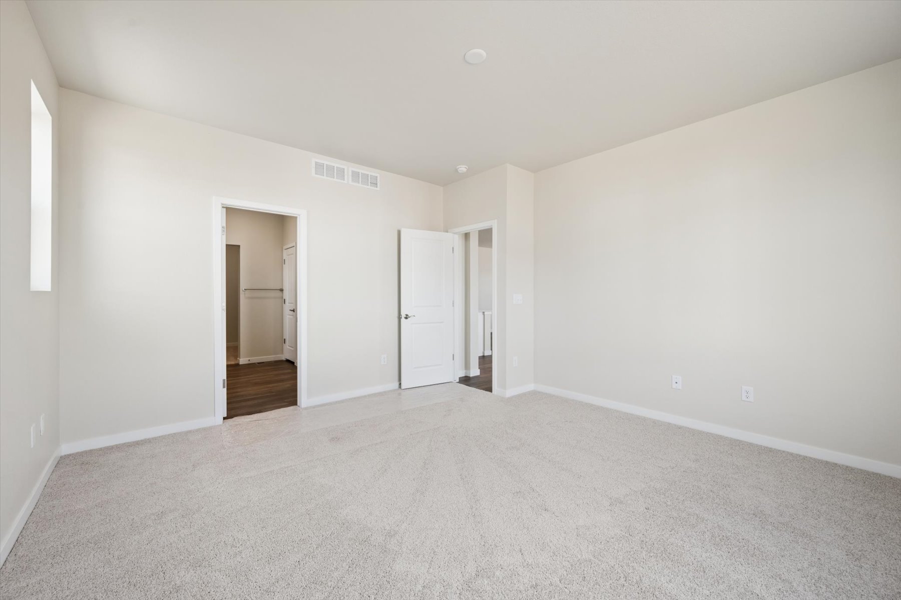 A hallway with white walls.