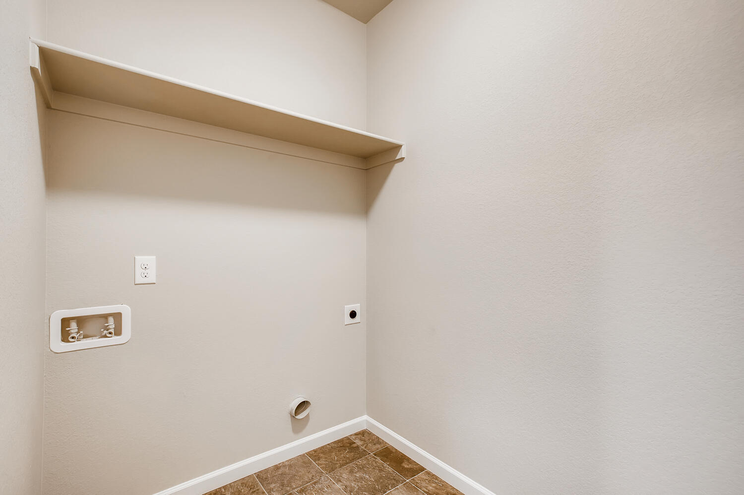 A white wall with a light switch.