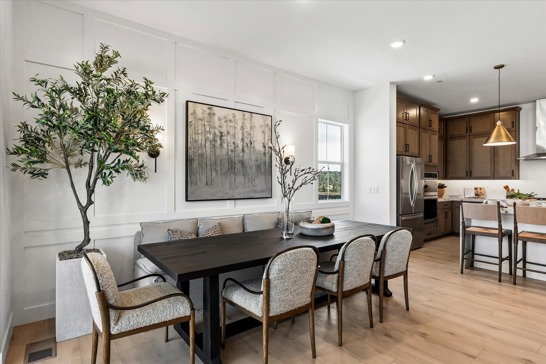 A kitchen with a dining table and chairs.
