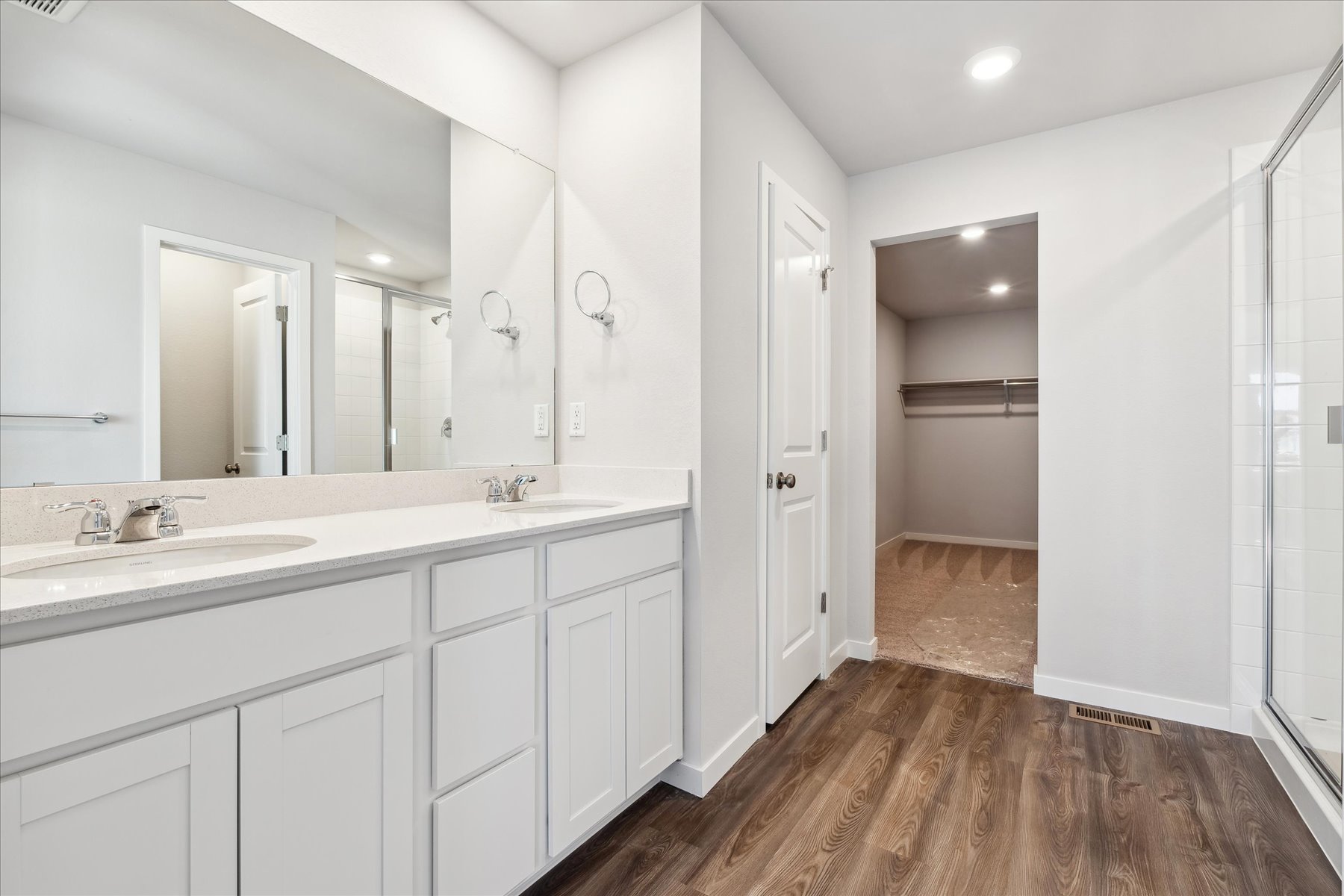 A bathroom with white cabinets.