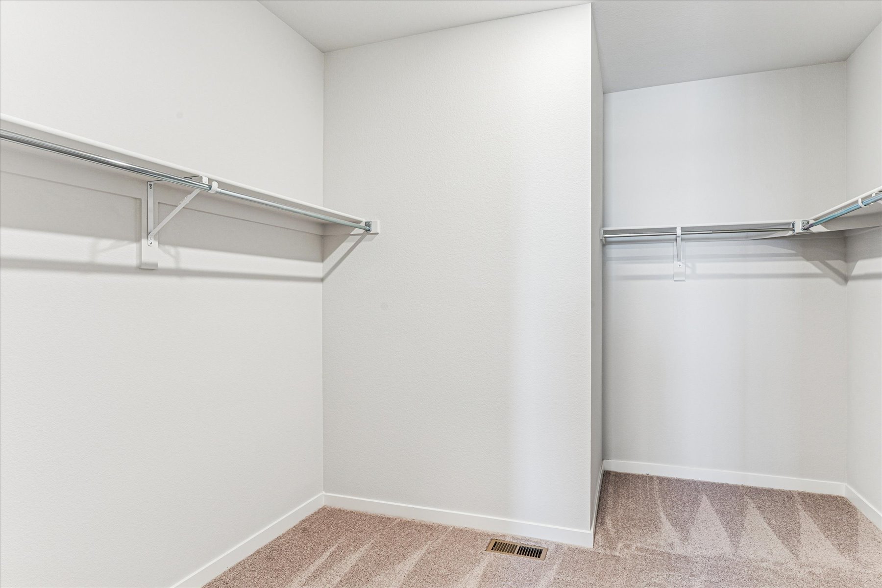 A white room with a metal railing.