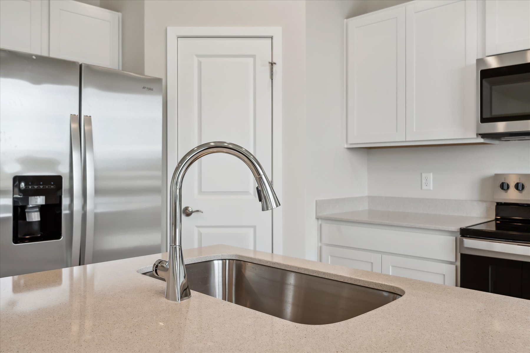 A kitchen with a stainless steel sink.