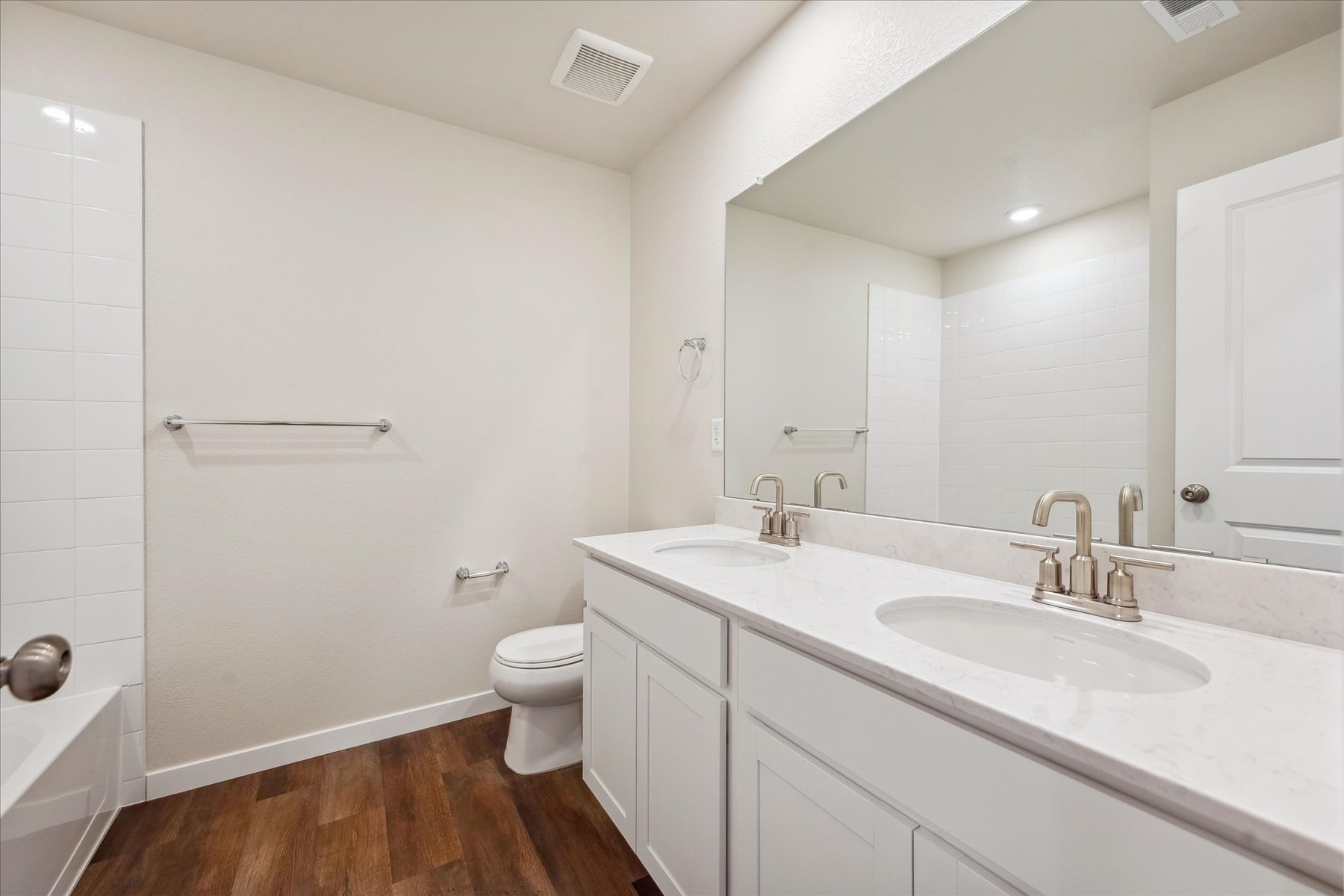 A bathroom with a tub sink and toilet.