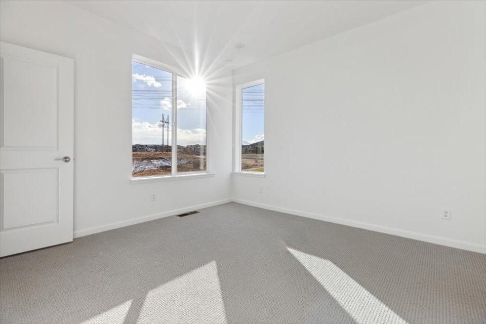 A room with a window and a door.