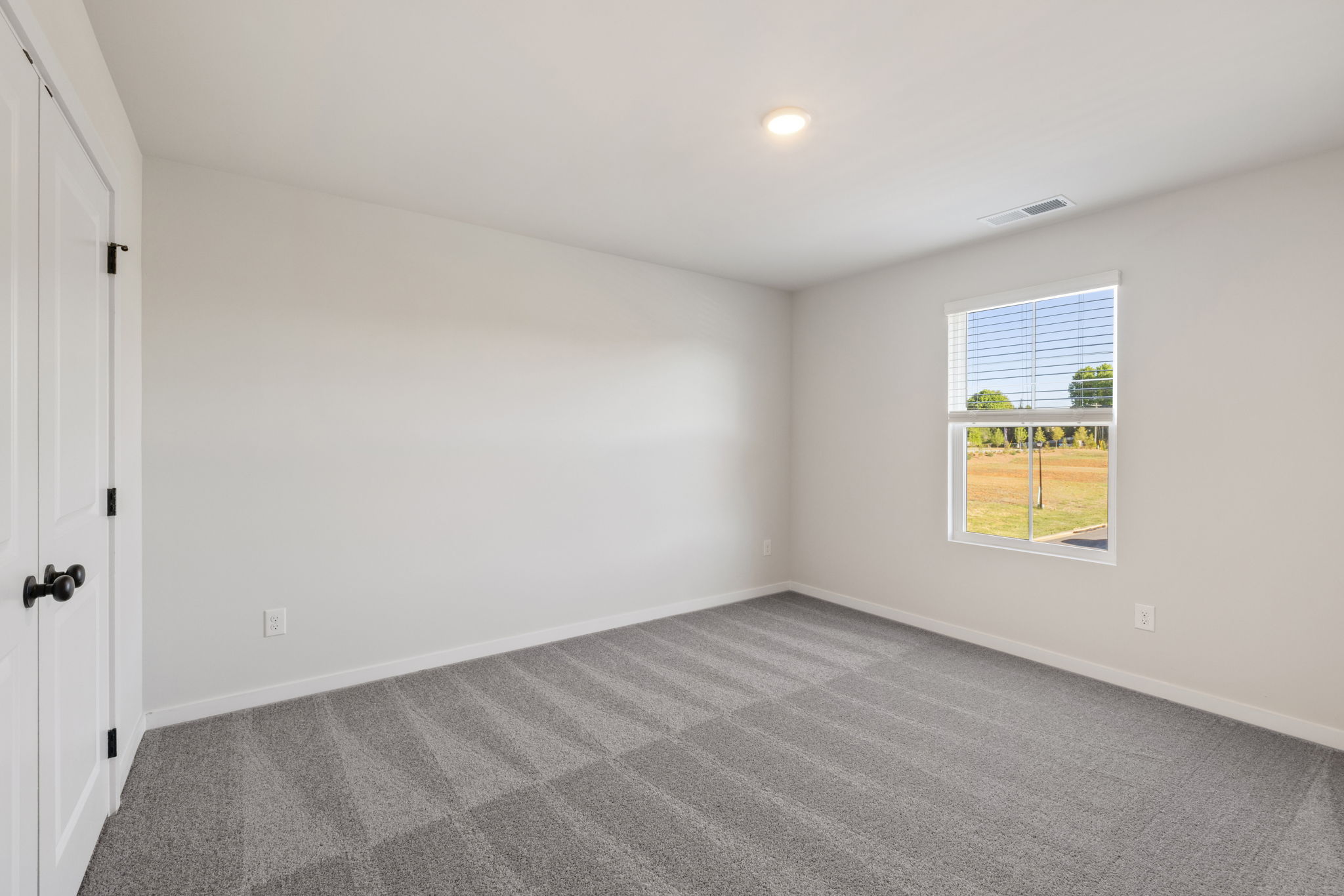 A room with a window and a door.