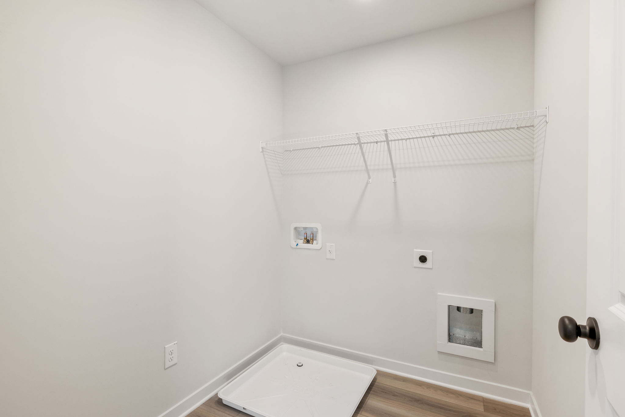 A white bathroom with a shower unit.