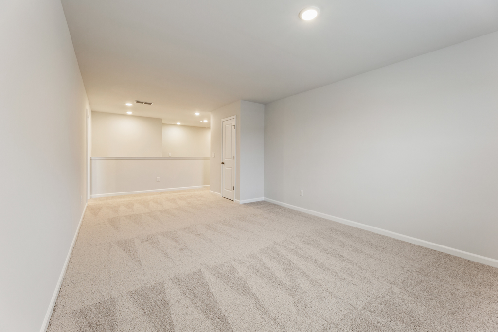 A hallway with white walls.
