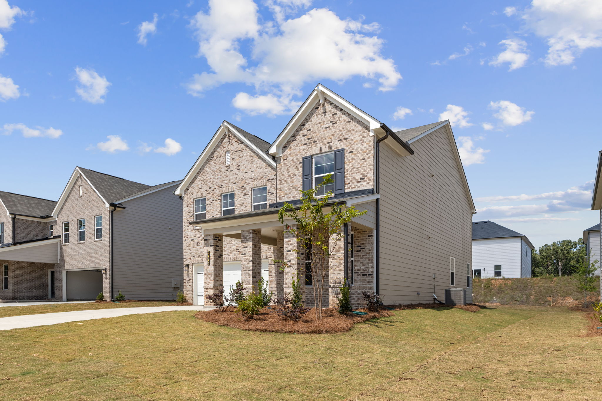 A house with a tree in the front.