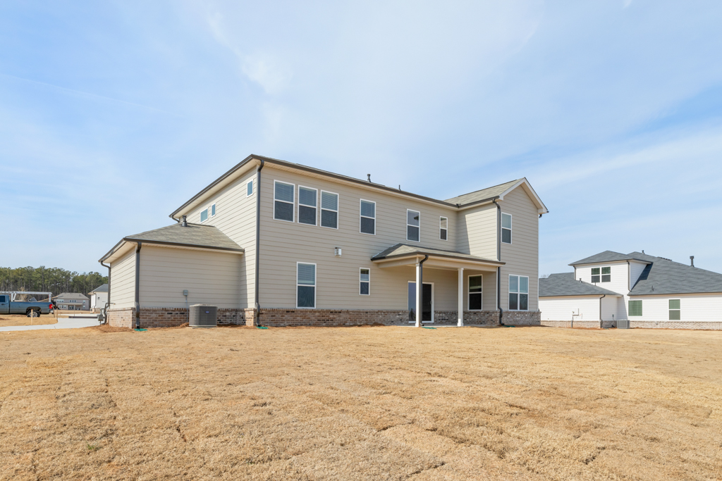 A house with a dirt lot.