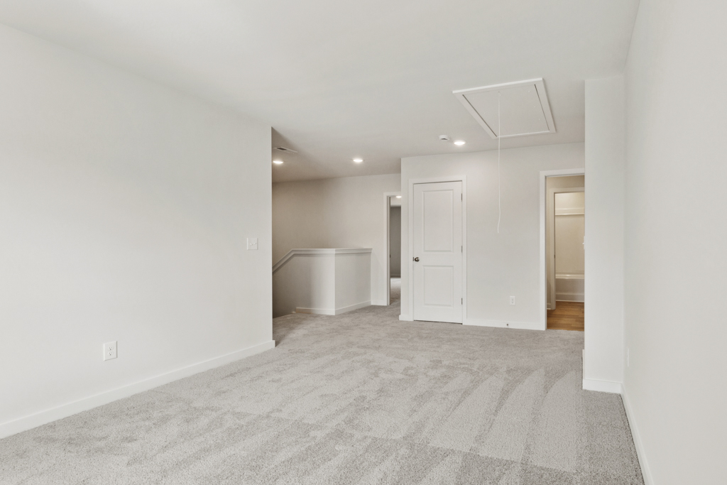 A hallway with white walls.