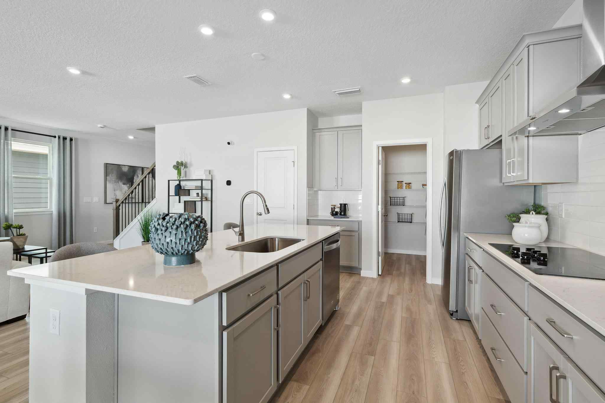 A kitchen with white cabinets.