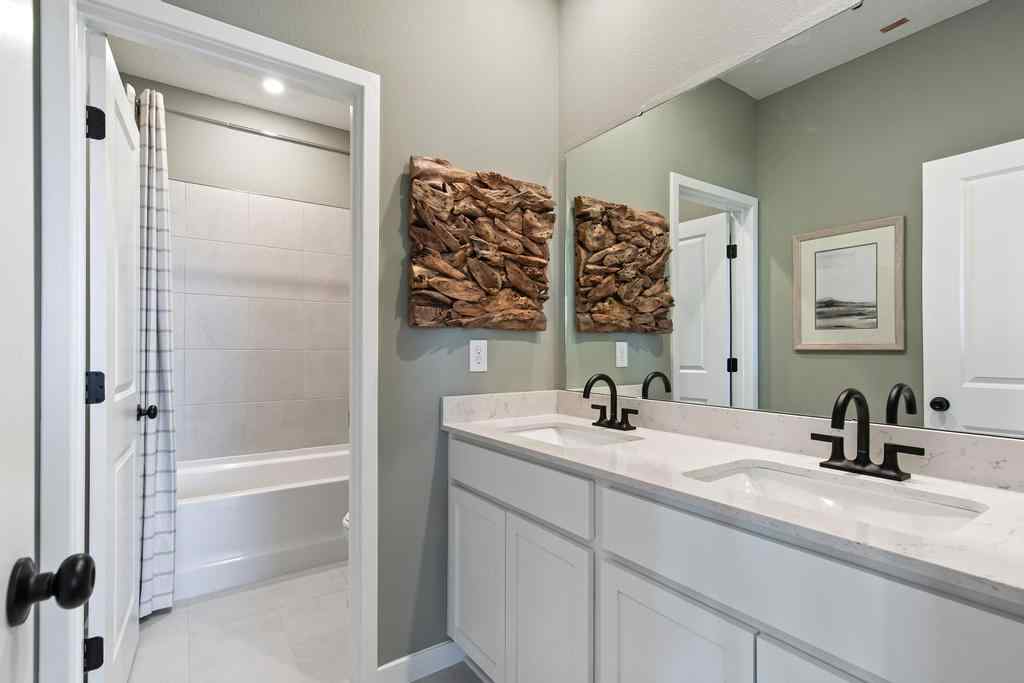 A bathroom with a sink and a shower.