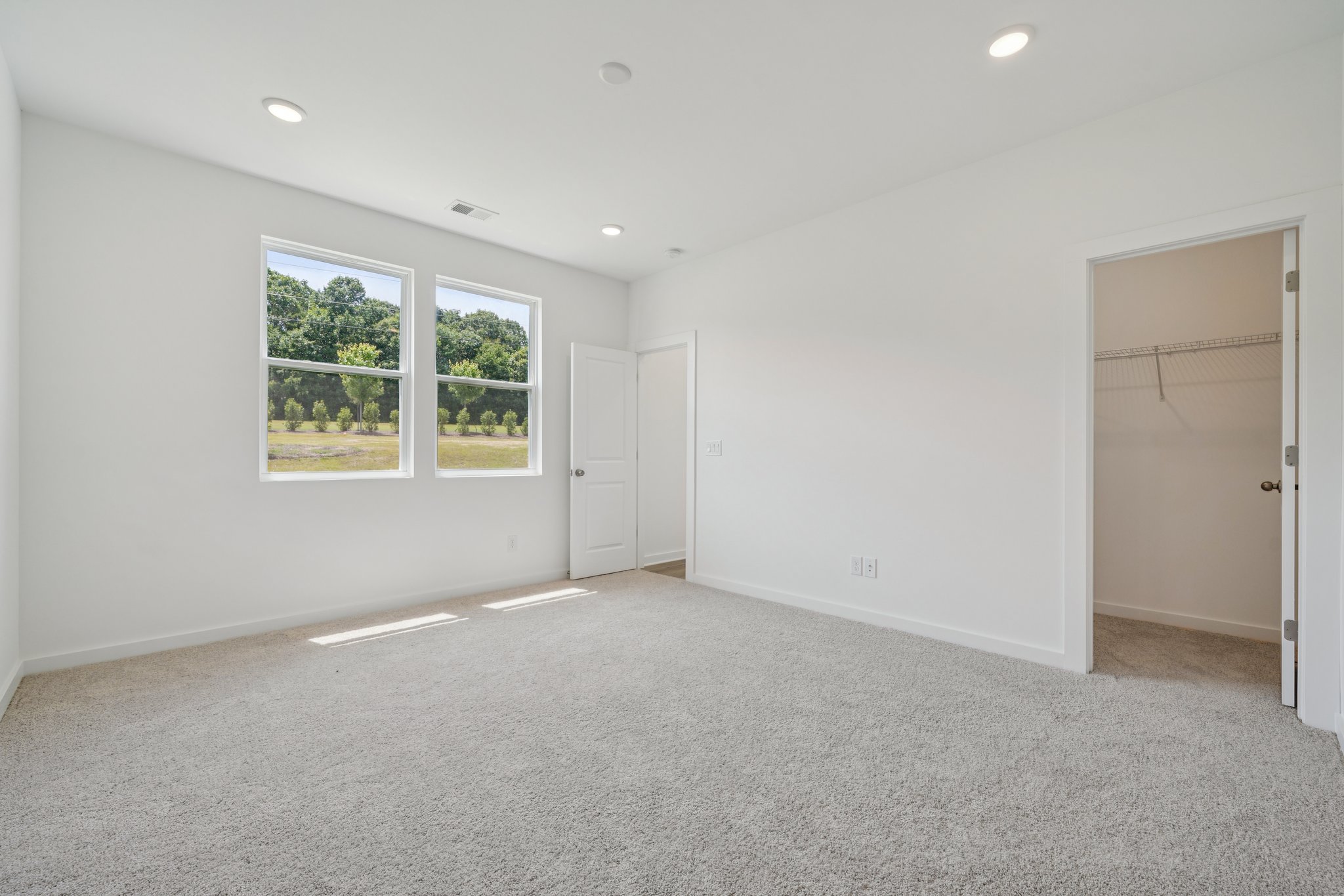 A room with white walls and a window.