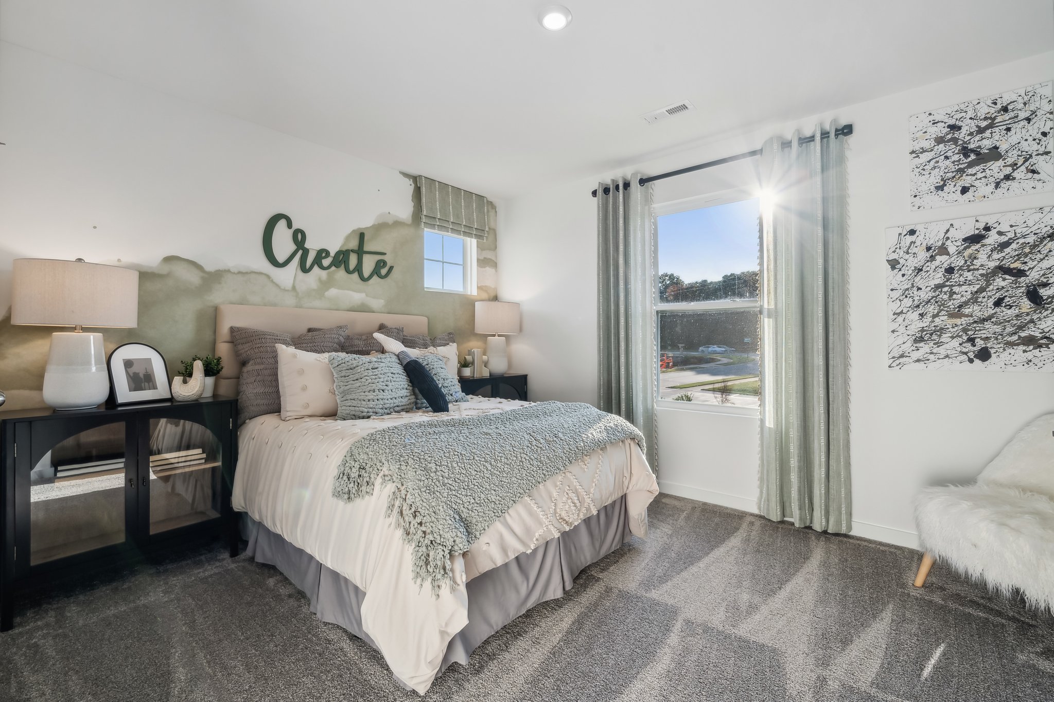 A bedroom with a large window.