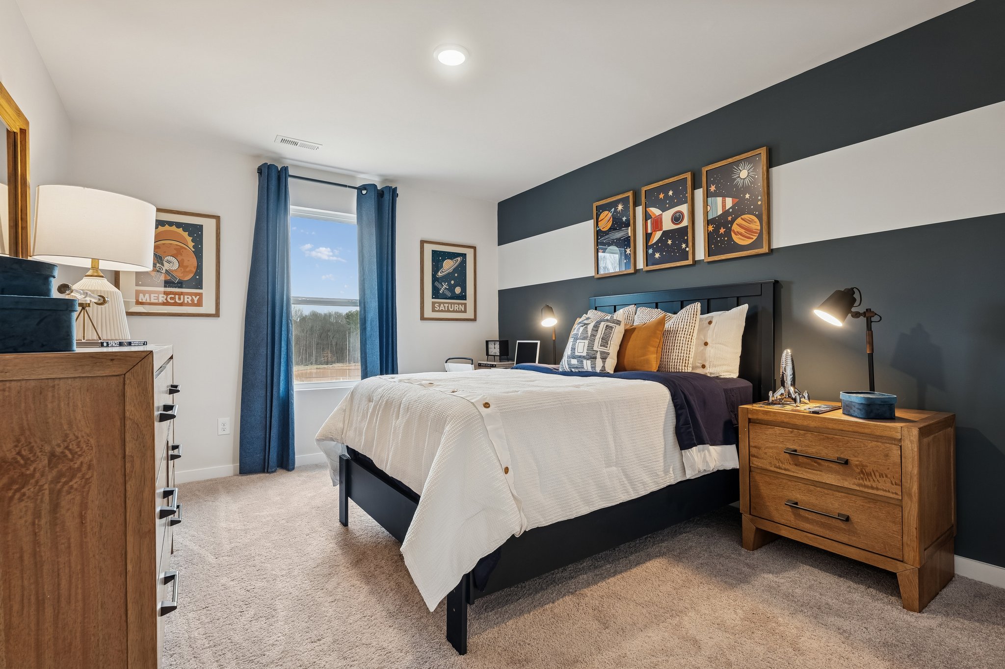 A bedroom with a bed and dresser.