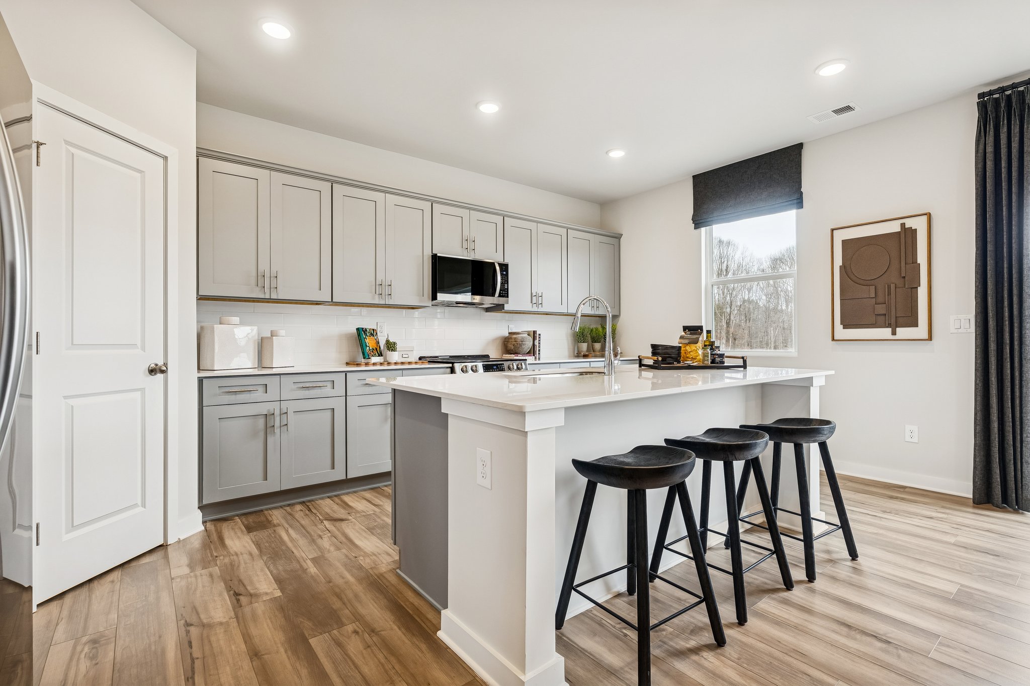 A kitchen with stools and a table.