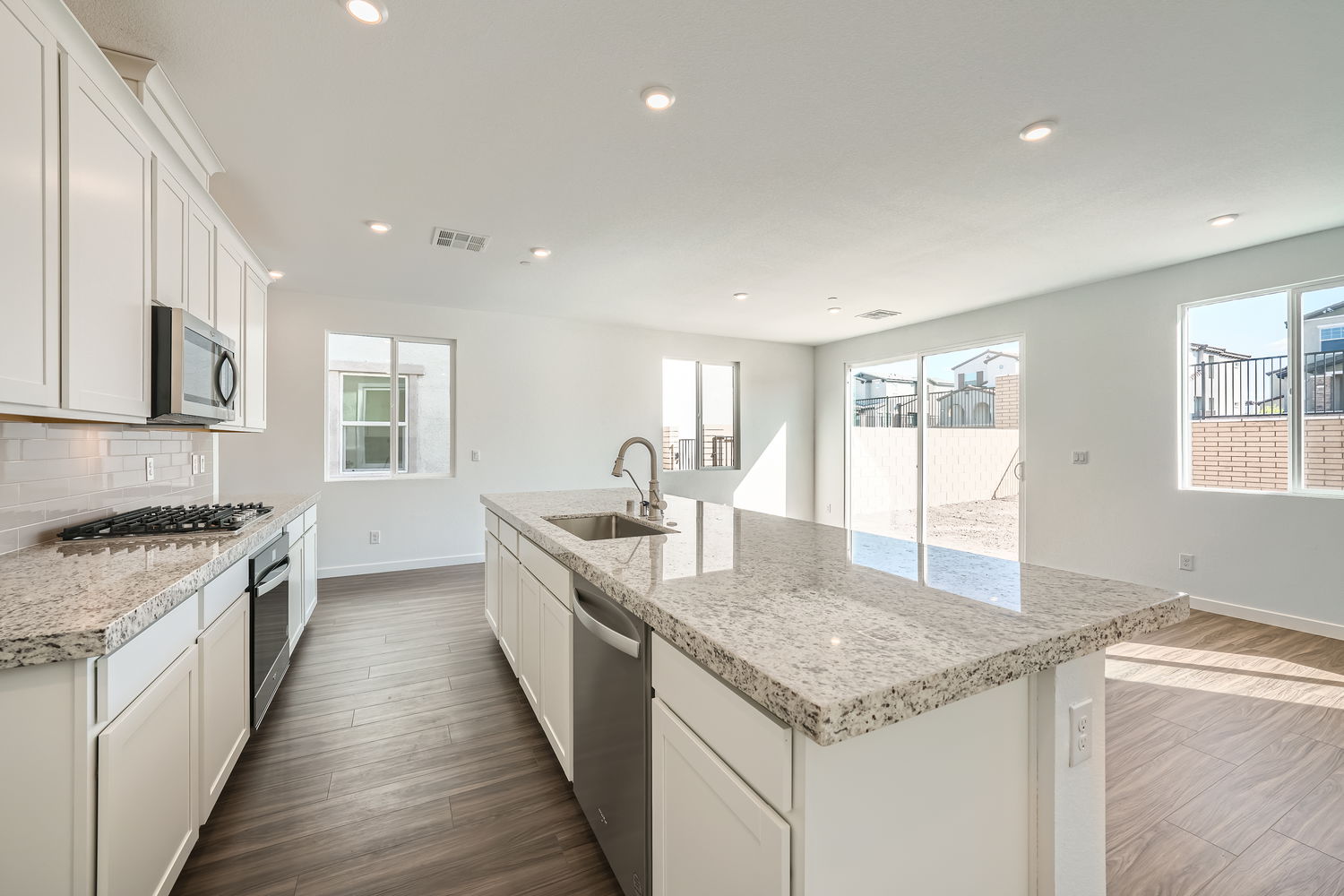 A kitchen with marble counters.