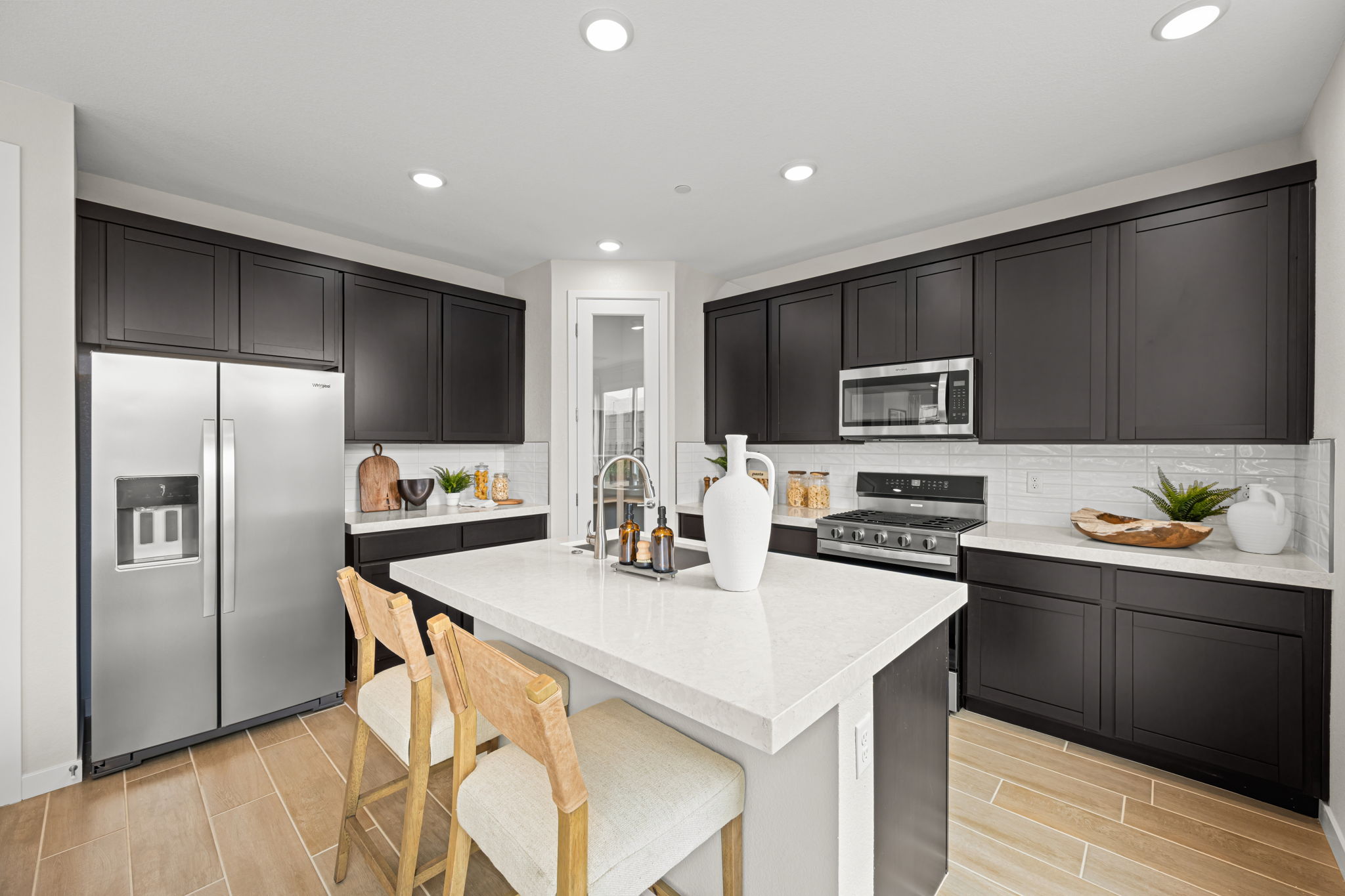 A kitchen with black cabinets.