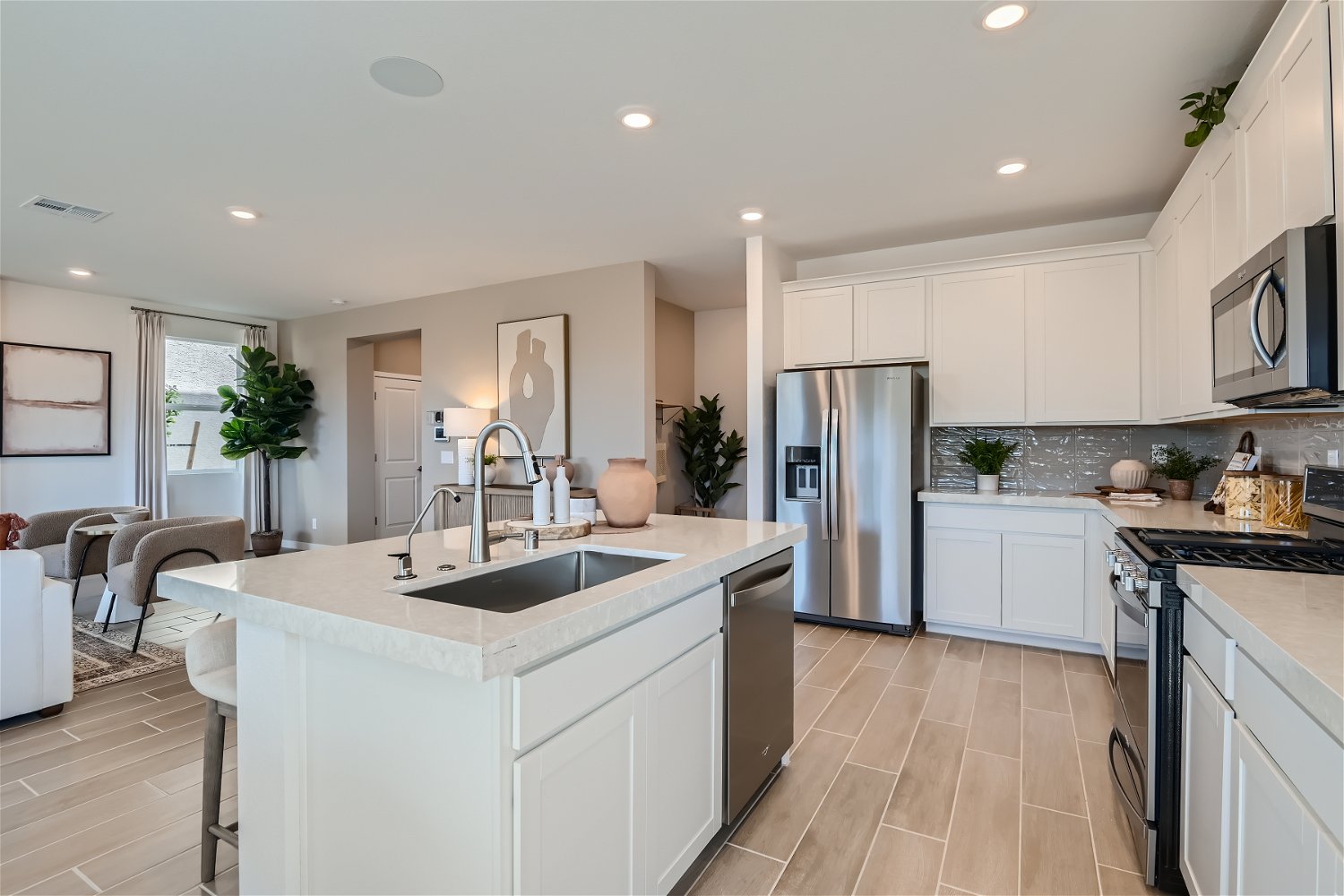 A kitchen with white cabinets.