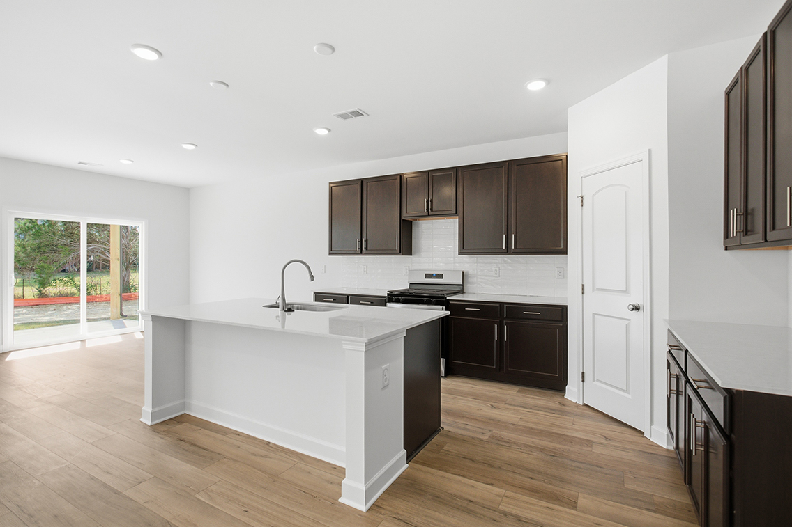 A kitchen with black cabinets.