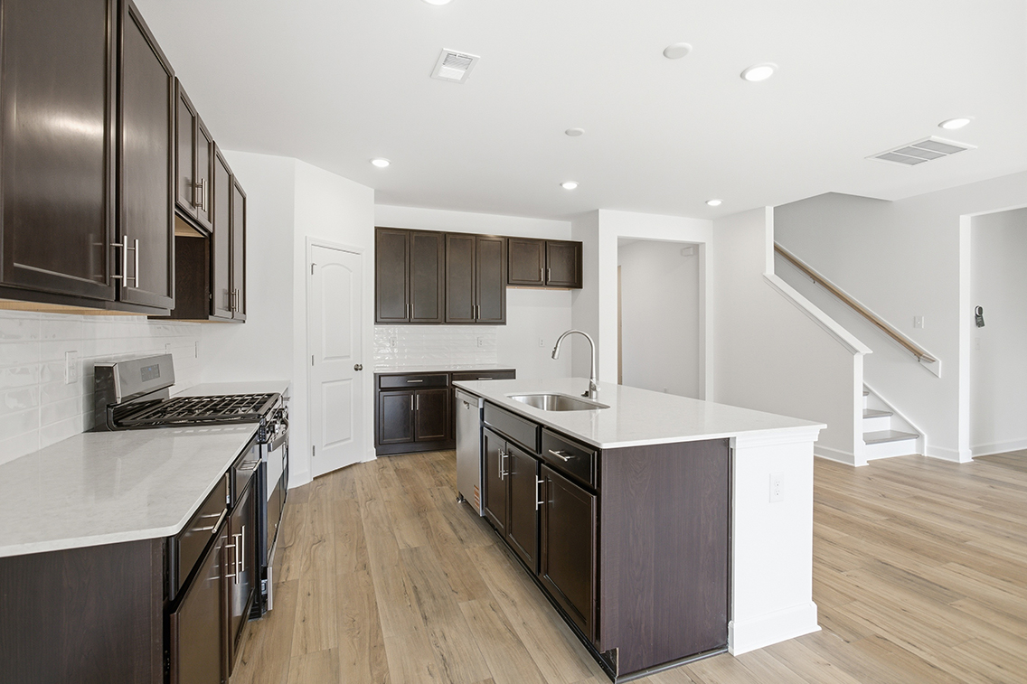 A kitchen with black cabinets.