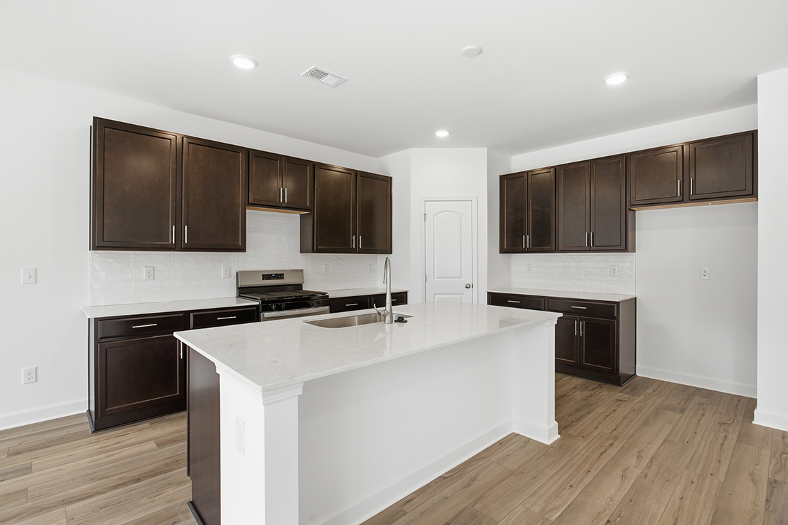 A kitchen with wooden cabinets.